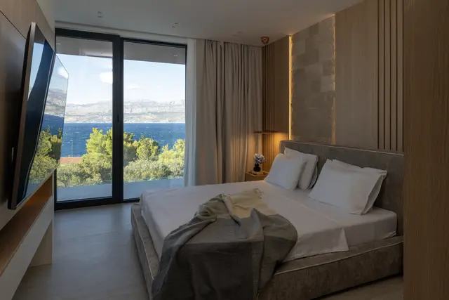 Bedroom with a swivel television and the Adriatic beyond