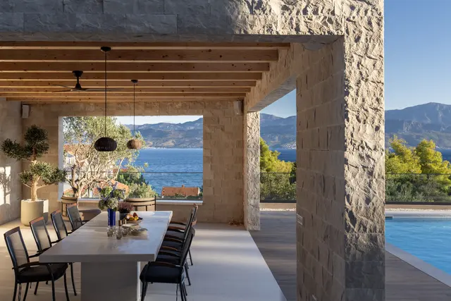 Outdoor dining under the oak-beamed pavilion