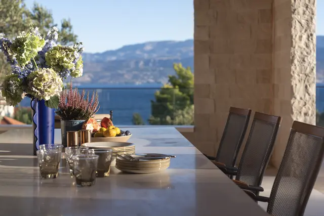Table laid with flowers and fruit above the bay