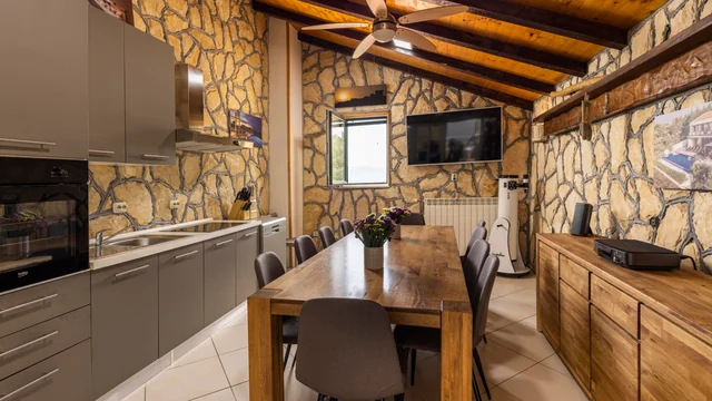 Kitchen and dining under stone and beams